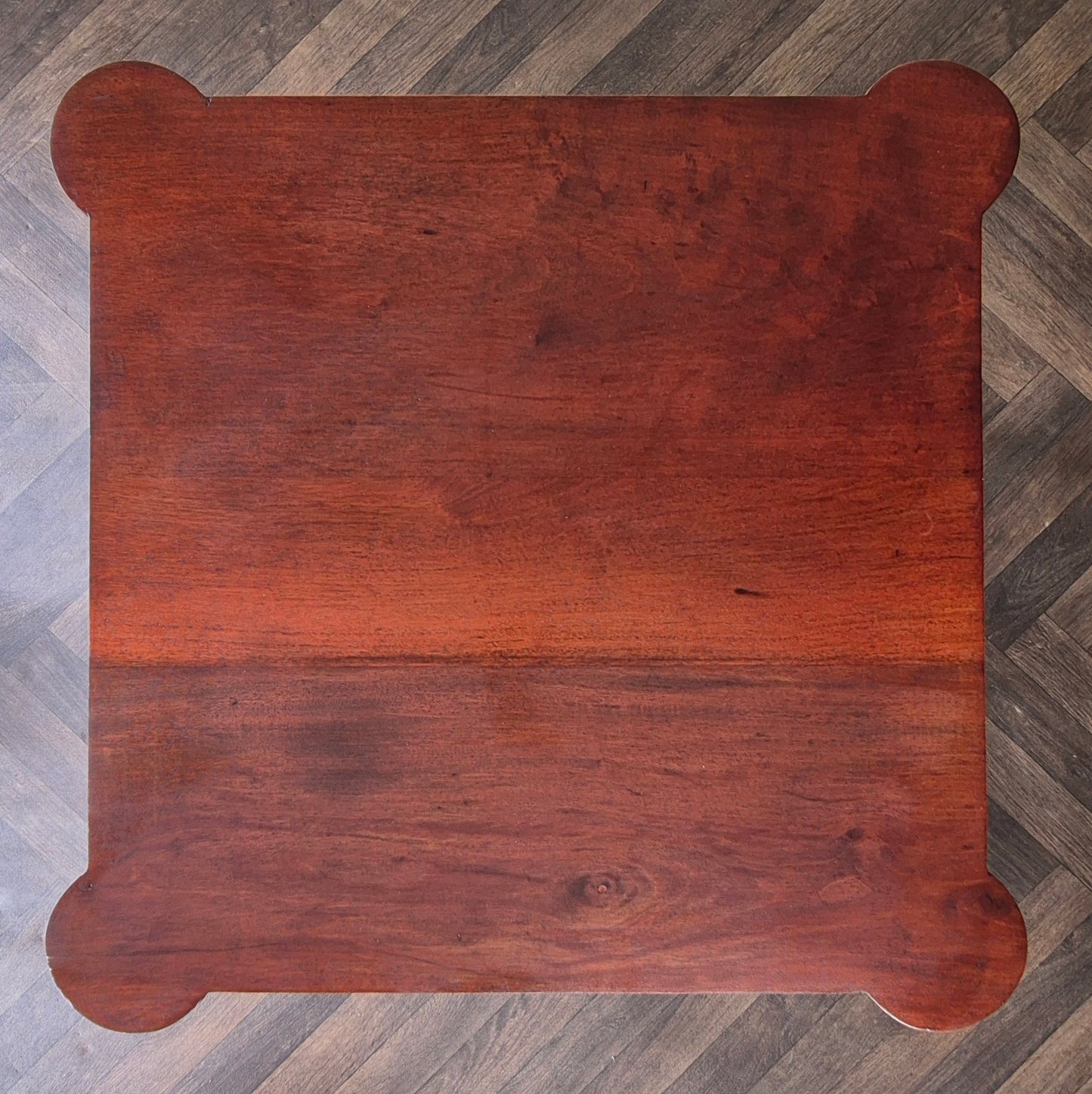 Wooden table top on a herringbone patterned floor